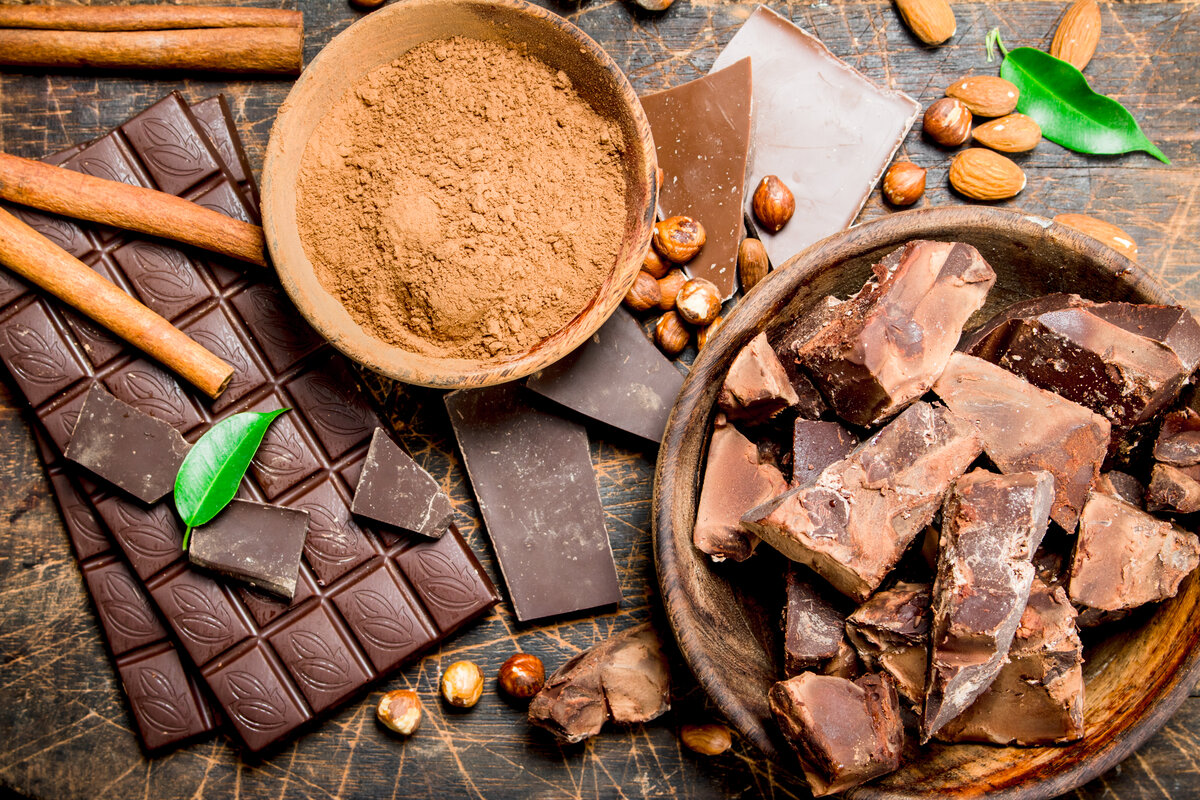 Peruvian Chocolate background. Chocolate with cocoa powder and cinnamon. On a wooden background.