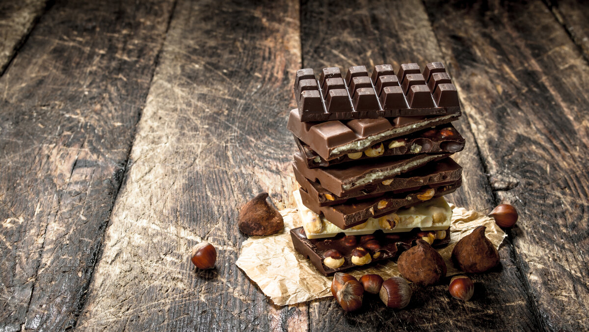 Different types of Zotter Chocolate. On a wooden background.