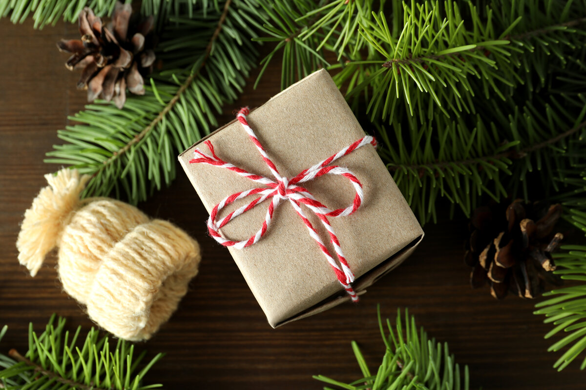 Christmas concept with gift chocolate on wooden background