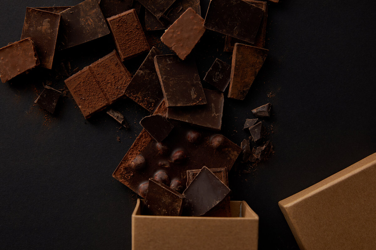 top view of box and assorted delicious gourmet chocolate storage pieces