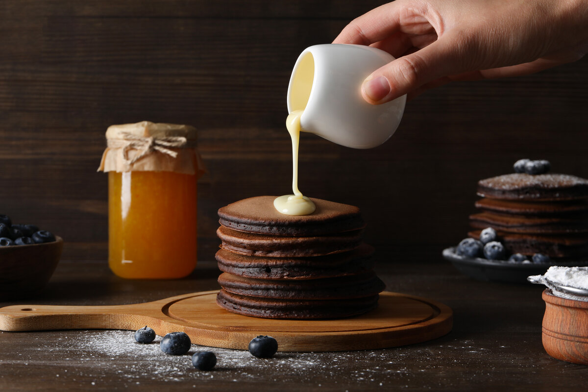 Concept of sweet food, tasty pancakes cooking with chocolate