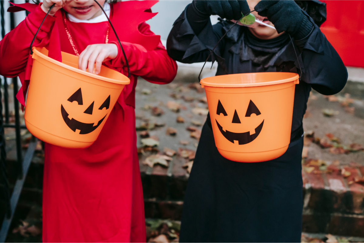 Kids with Halloween Candy containers