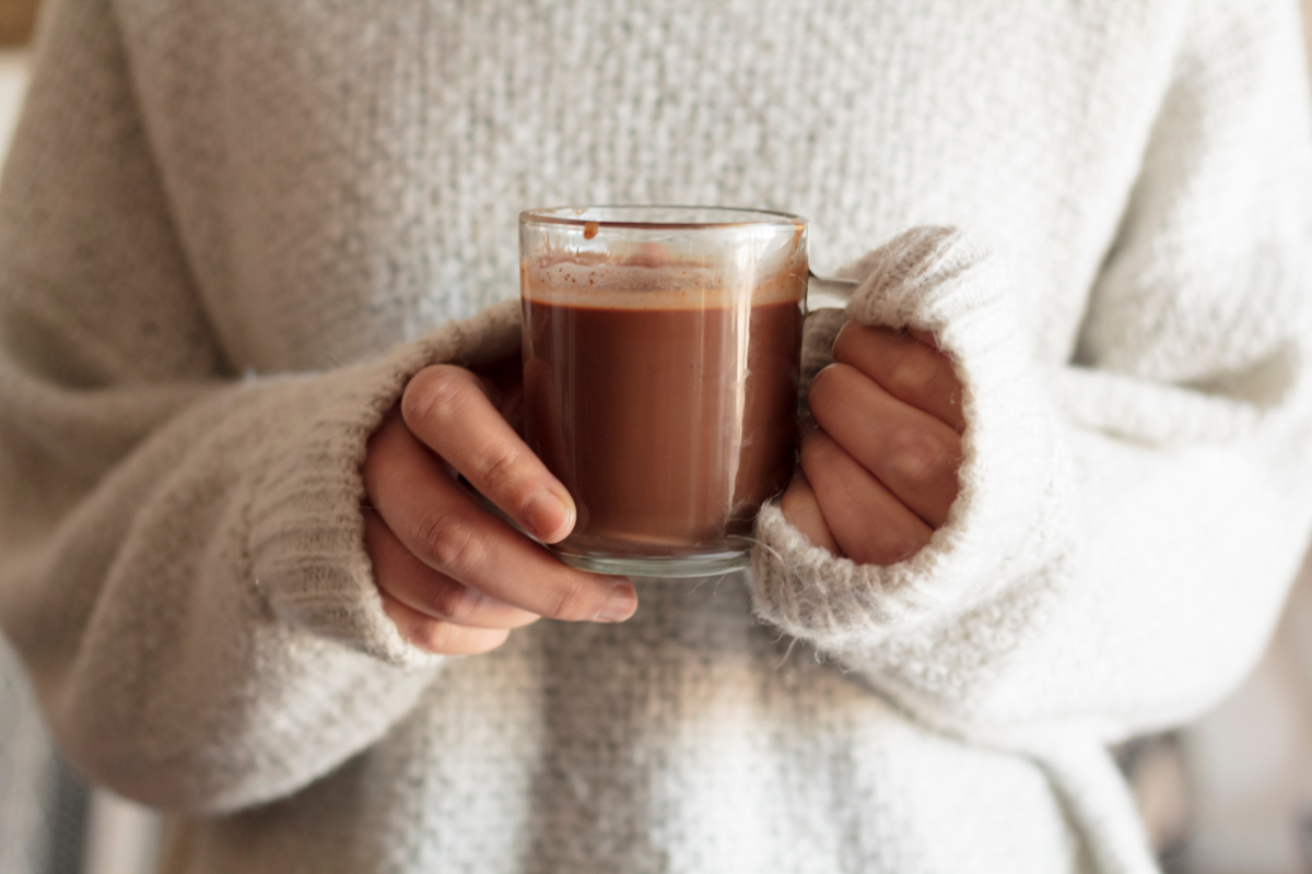 woman hands holding hot chocolate