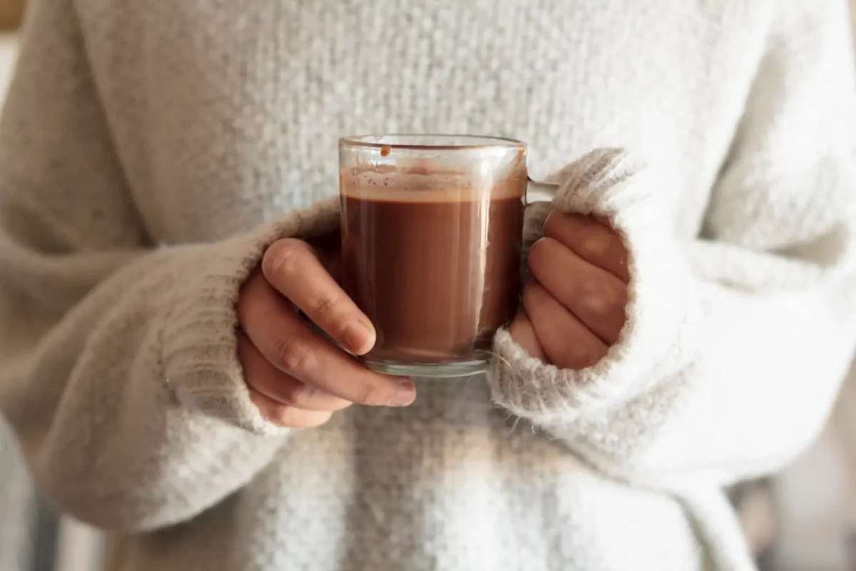 Reasons to Substitute Your Morning Cup of Coffee for Drinking Chocolate 6 woman hands holding hot chocolate